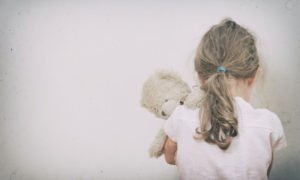 Little girl crying in the corner.