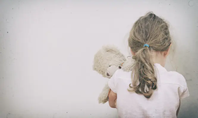 Little girl crying in the corner.